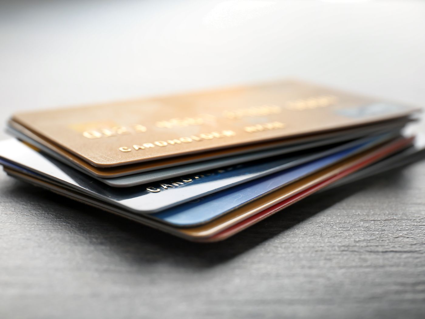 A pile of credit cards on a table